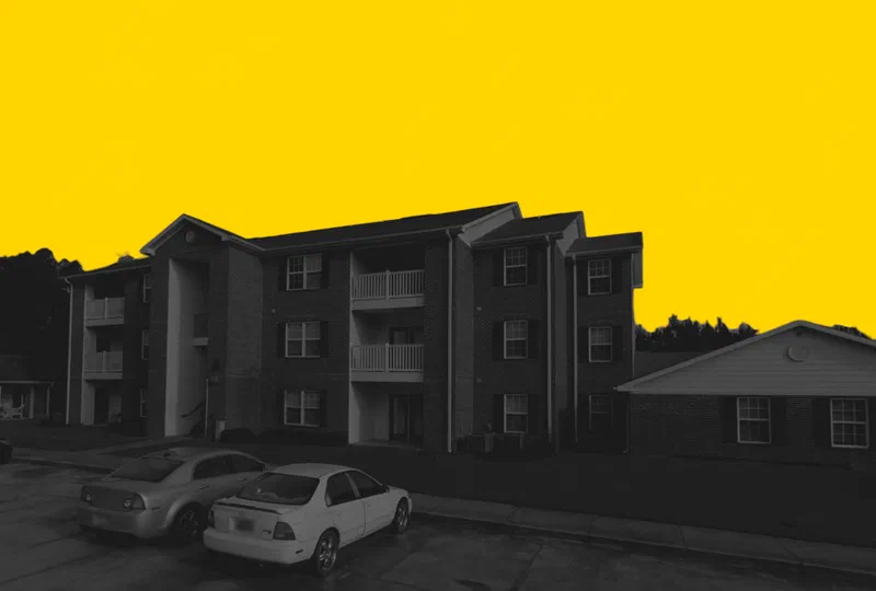 Gables Crossing in Centreville, Alabama, a three-story apartment building with private balconies, in a yellow and black duotone treatment.