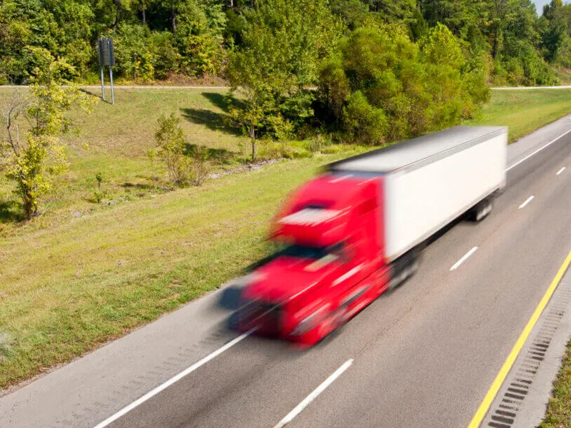 An over-the-road truck running the kind of freight DNA Supply Chain Solutions moves for Alabama Lightwave.