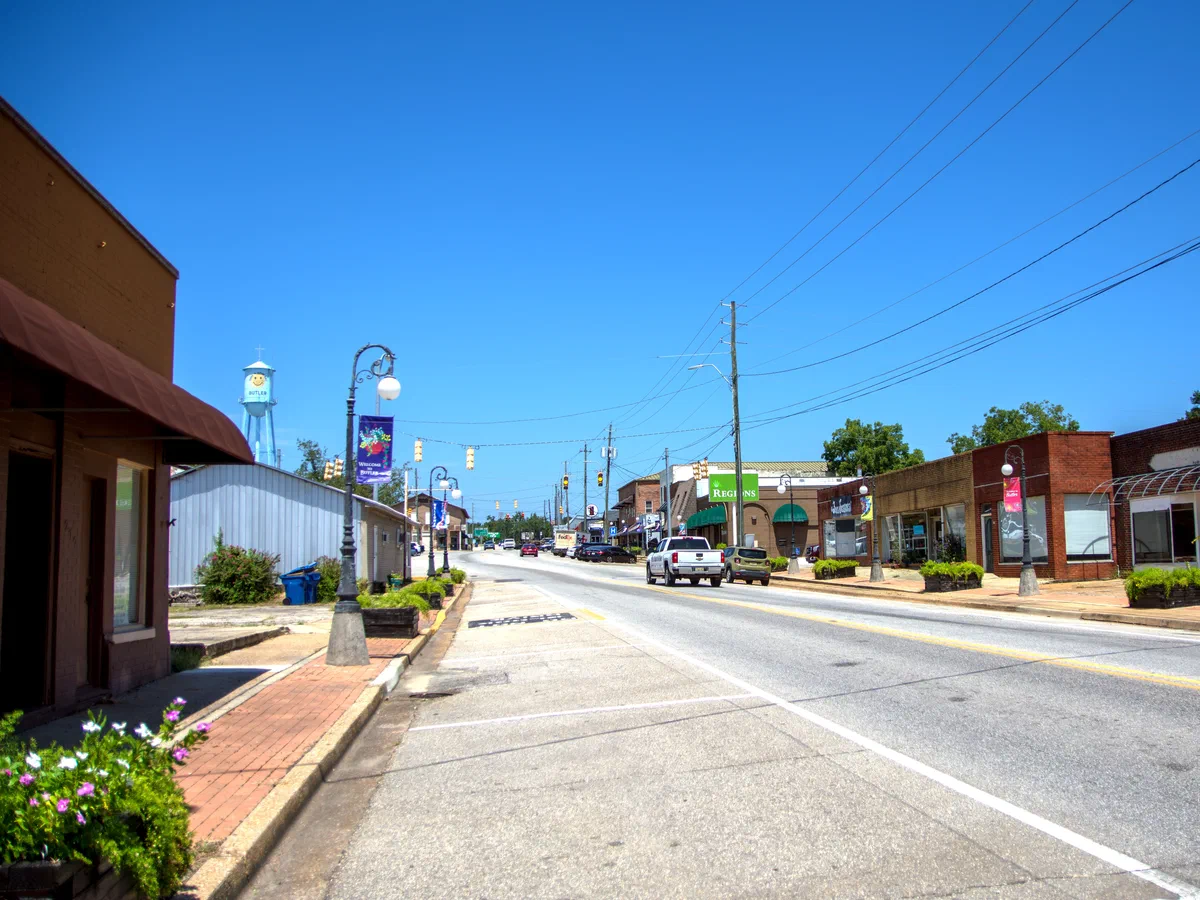 Downtown Butler, Alabama with storefronts and the Smiley Face water tower