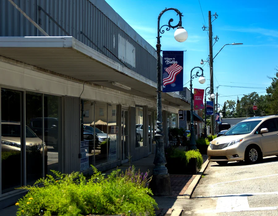 Downtown Butler storefronts and welcome banners in Choctaw County, Alabama