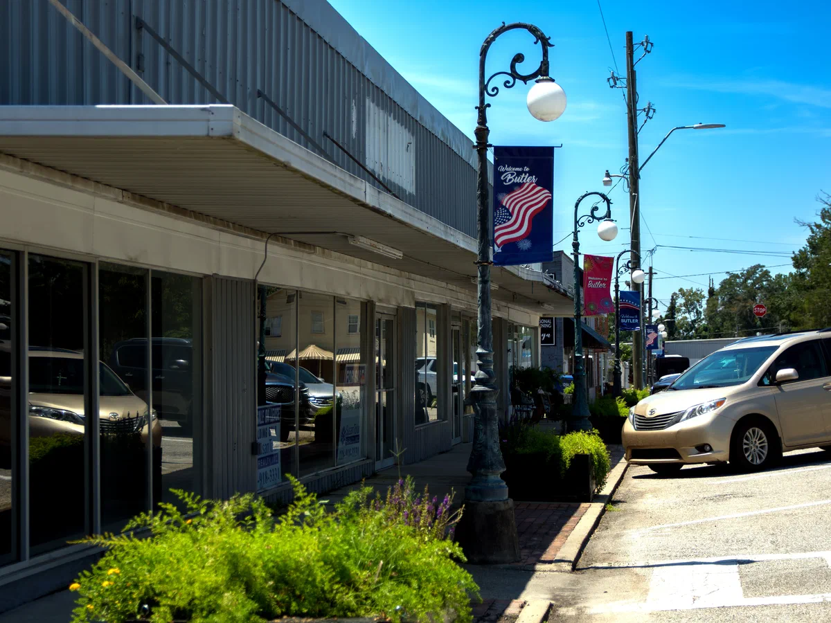 Downtown Butler storefronts and welcome banners in Choctaw County, Alabama